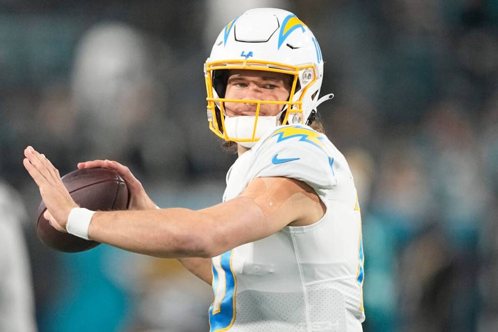 Los Angeles Chargers quarterback Justin Herbert (10) warms up before an NFL wild-card football ...