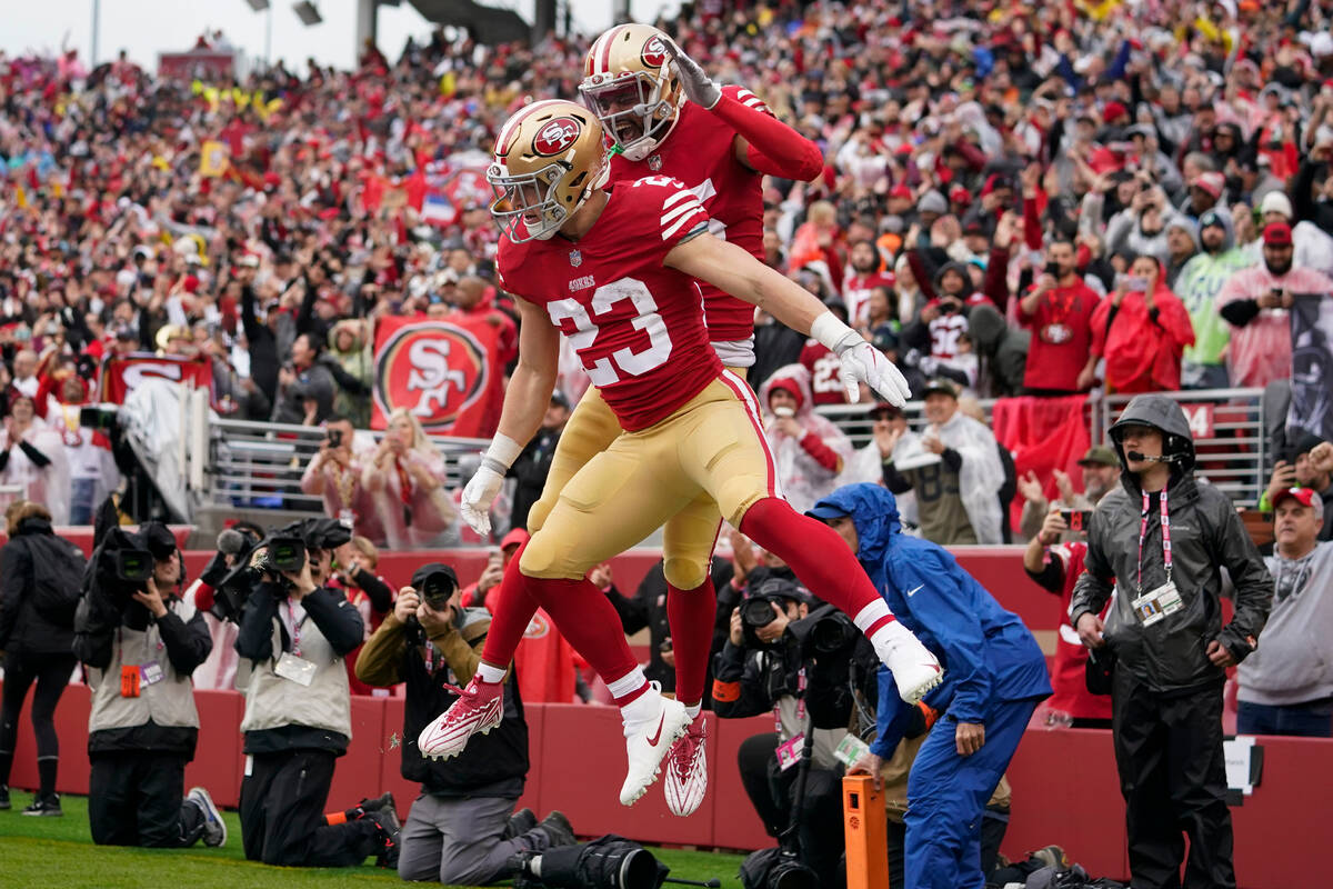 San Francisco 49ers running back Christian McCaffrey (23) is congratulated by wide receiver Jau ...