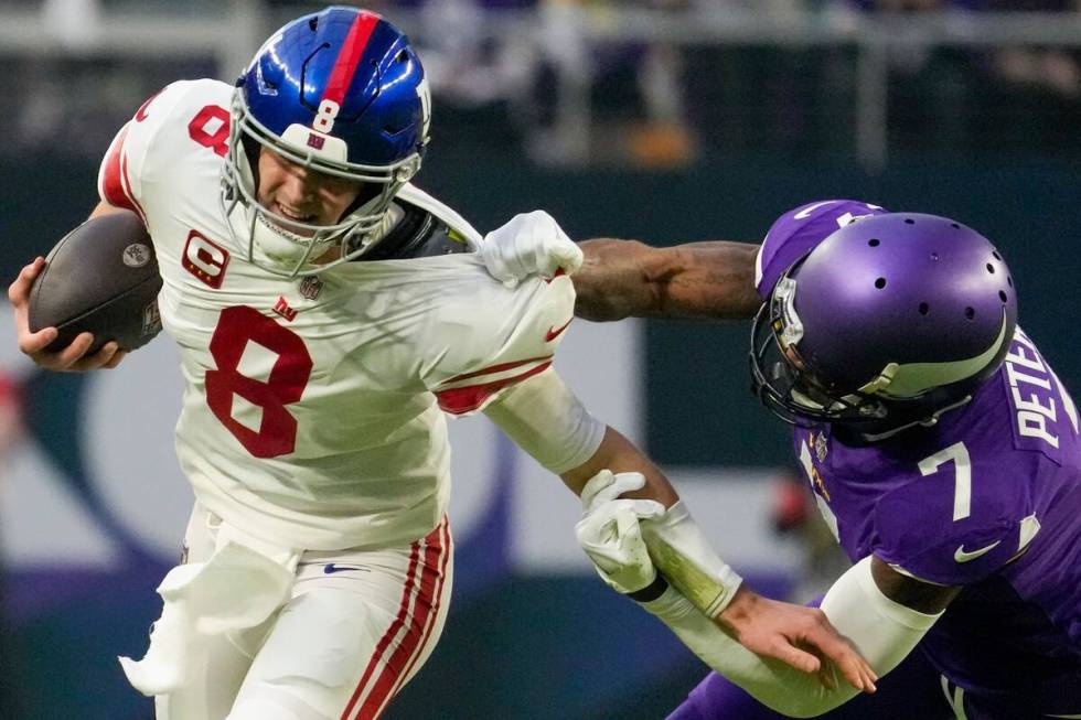 New York Giants' Daniel Jones tries to get away from Minnesota Vikings' Patrick Peterson during ...