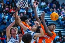 Bishop Gorman guard Jaxon Richardson (5) looks to a loose ball after colliding with Centennial ...