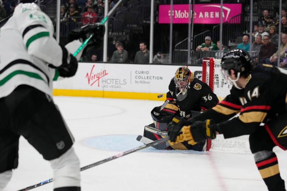 Vegas Golden Knights goaltender Logan Thompson (36) blocks a shot by Dallas Stars center Radek ...