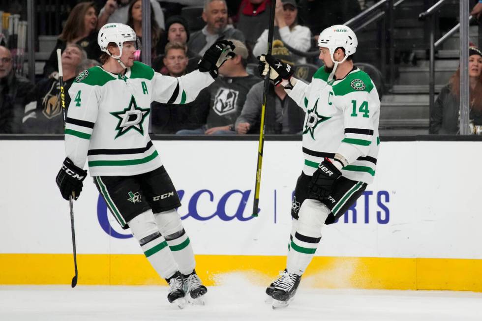 Dallas Stars defenseman Miro Heiskanen (4) celebrates after left wing Jamie Benn (14) scored ag ...