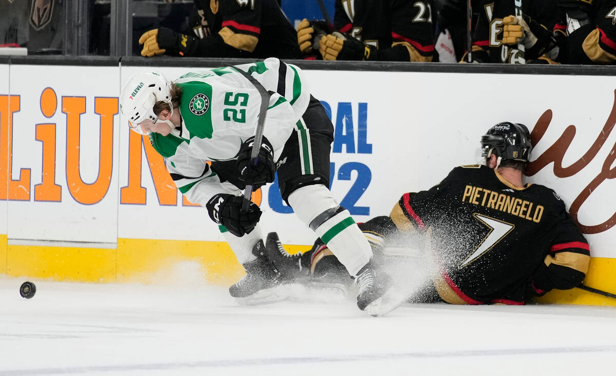 Vegas Golden Knights defenseman Alex Pietrangelo (7) falls into the boards beside Dallas Stars ...