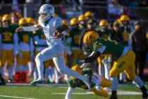 Bishop Gorman QB Micah Alejado (12) catches some air as he leaps from a tackle attempts by Bish ...