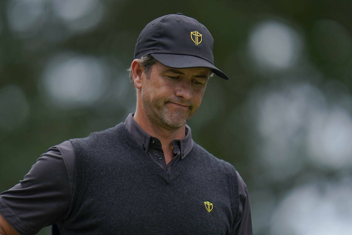 Adam Scott, of Australia, reacts to his ball's flight off the sixth tee during their singles ma ...