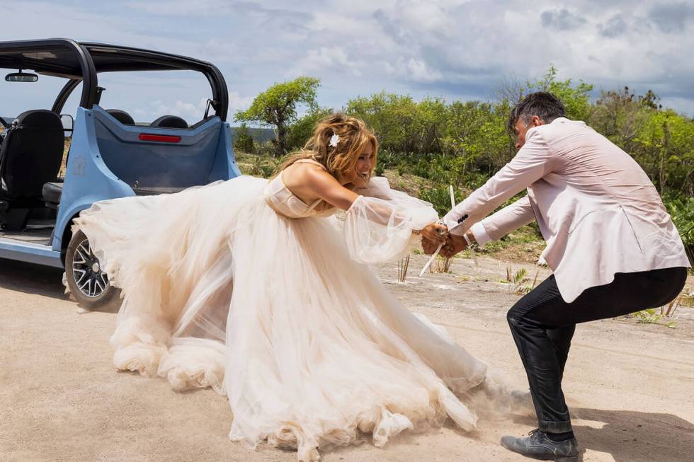 Jennifer Lopez as Darcy Rivera and Josh Duhamel as Tom Fowler in Shotgun Wedding. Photo Credit: ...