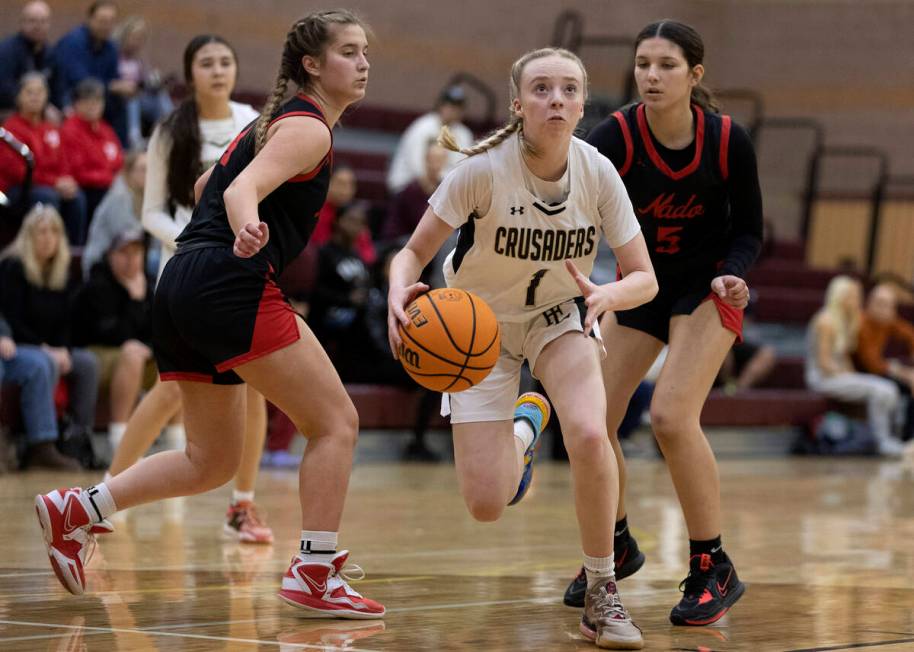 Faith Lutheran’s Sami Monighetti (1) dribbles to shoot surrounded by Coronado’s S ...