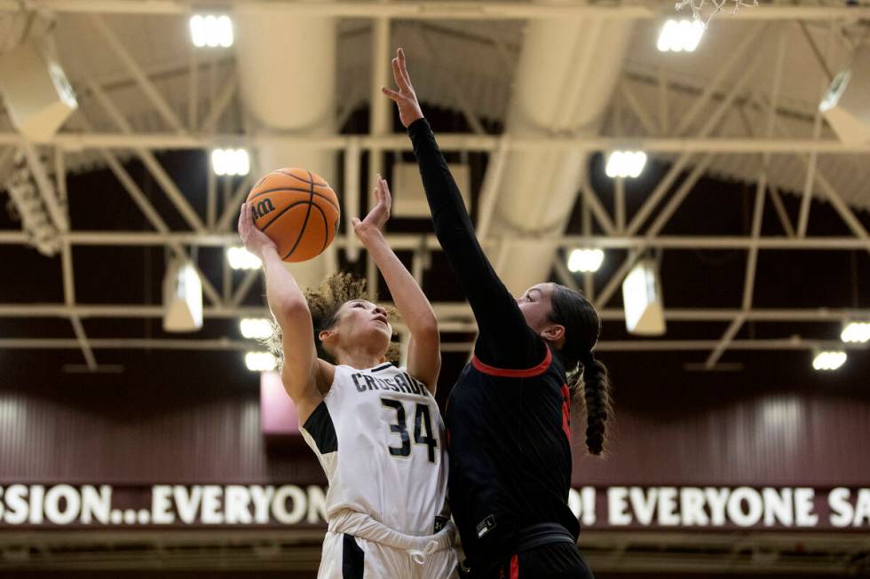 Faith Lutheran’s Leah Mitchell (34) shoots against Coronado’s Ashtyn Wick, right, ...