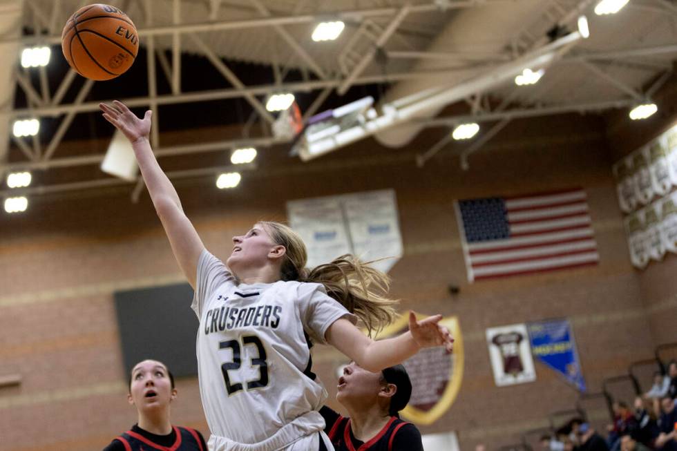 Faith Lutheran’s Raina Forgue (23) attempts a layup against Coronado during a girls high ...