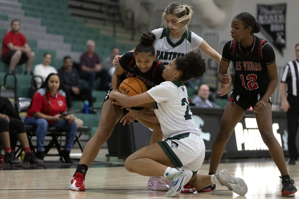 Las Vegas’ Vernonie Newson, center left, fights for the ball with Palo Verde’s Alana Conner ...