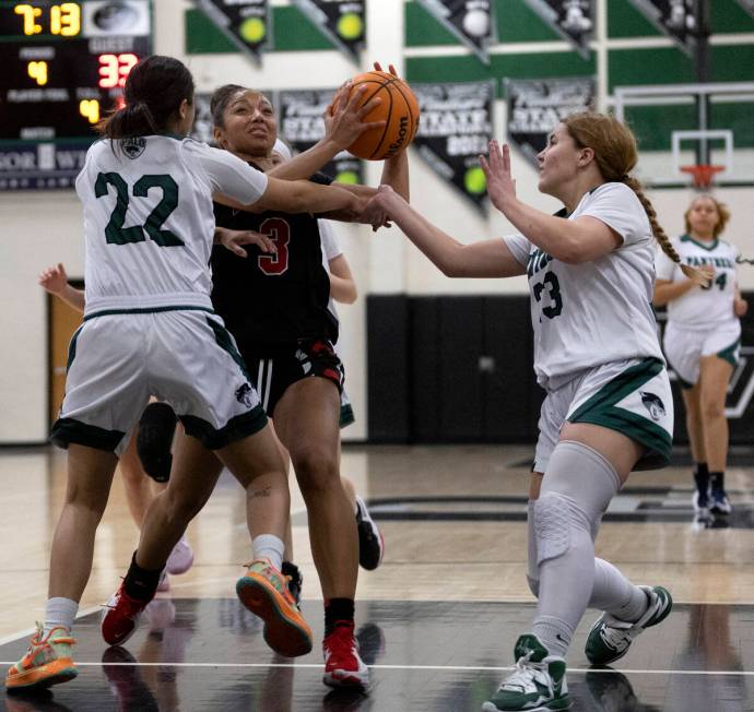 Las Vegas’ Vernonie Newson (3) drives toward the hoop against Palo Verde’s Sophia Rivera (2 ...