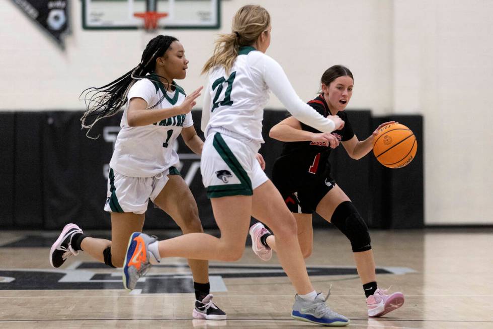 Las Vegas’ Layla Faught (1) dribbles around Palo Verde’s Arriona Wright (1) and Halle McKni ...