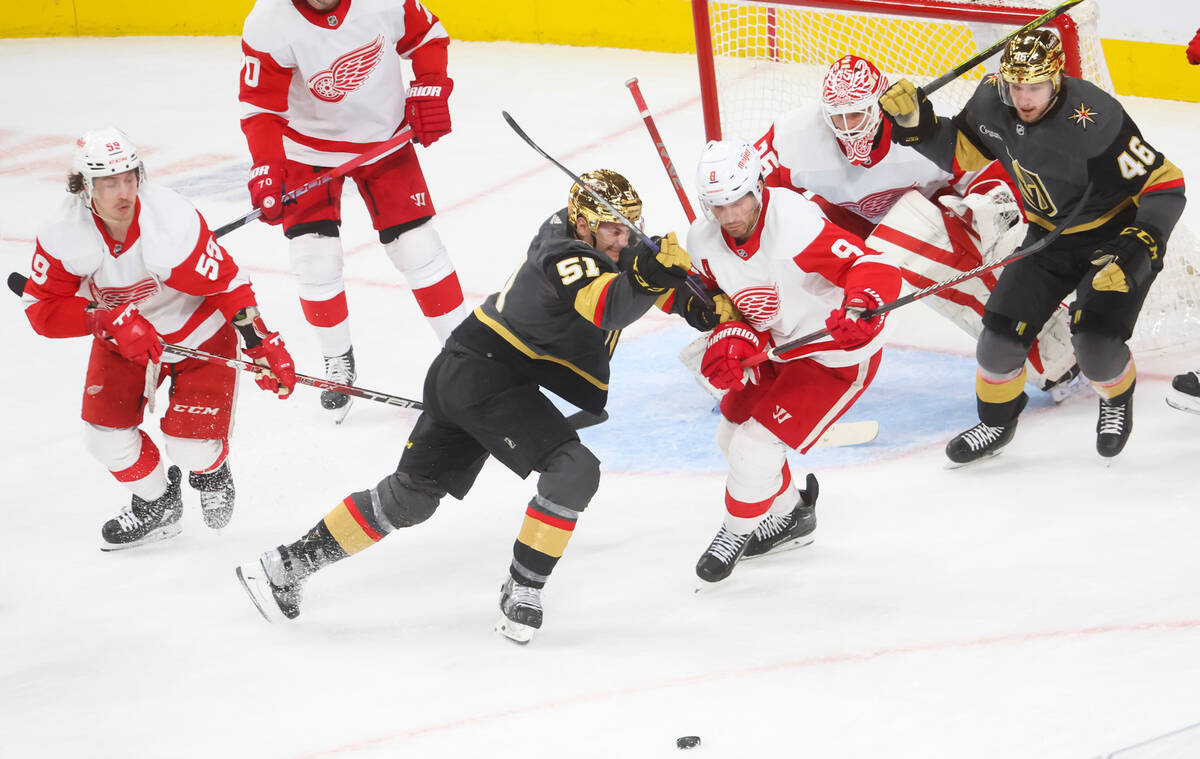 Golden Knights center Byron Froese (51) and Detroit Red Wings defenseman Ben Chiarot (8) fight ...