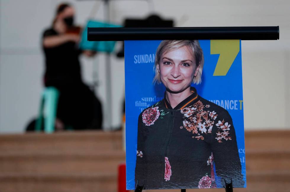 FILE - A musician plays a violin behind a photograph of cinematographer Halyna Hutchins during ...