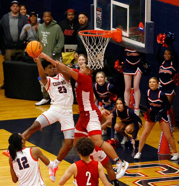 Coronado’s Josiah Cunningham (23) attempts a jump shot as Liberty’s Andre Porter ...