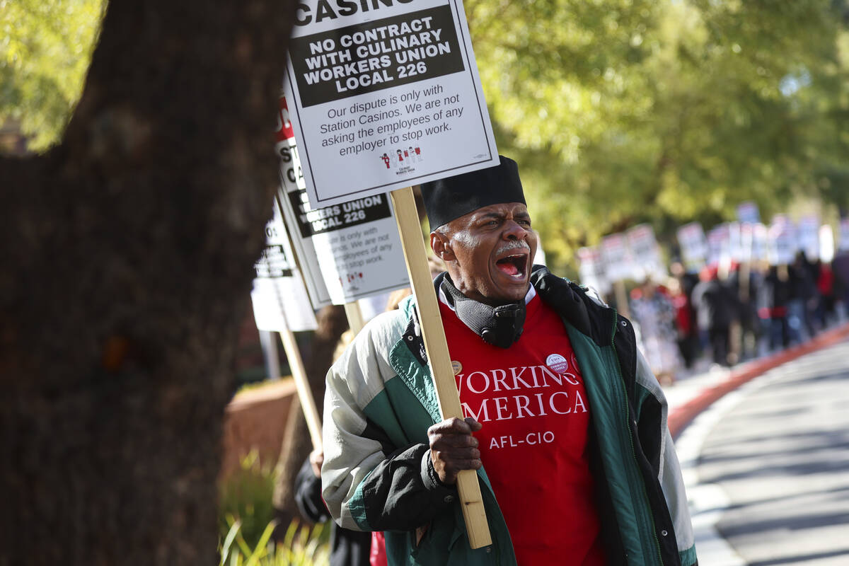 Culinary Workers Union Local 226 committee leader Henry Anthony Joyner pickets outside of Stati ...