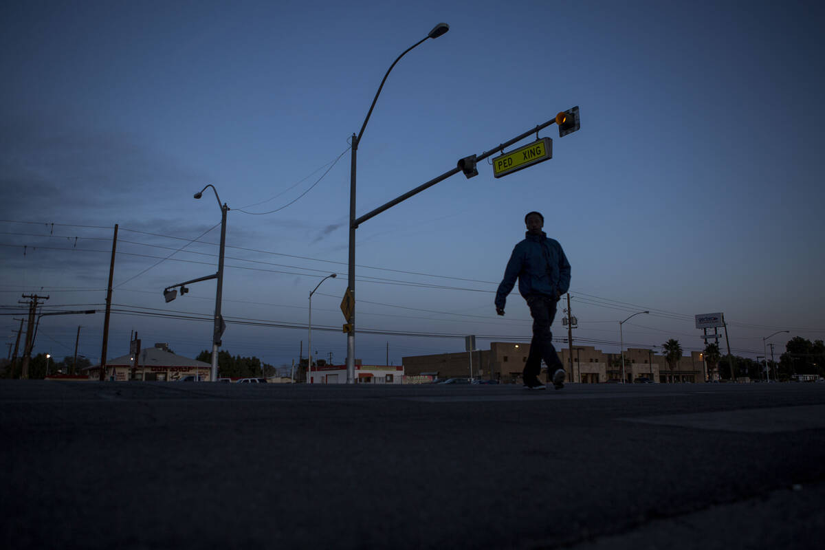 A pedestrian uses the crosswalk at the intersection of Whitney Avenue and Boulder Highway in La ...