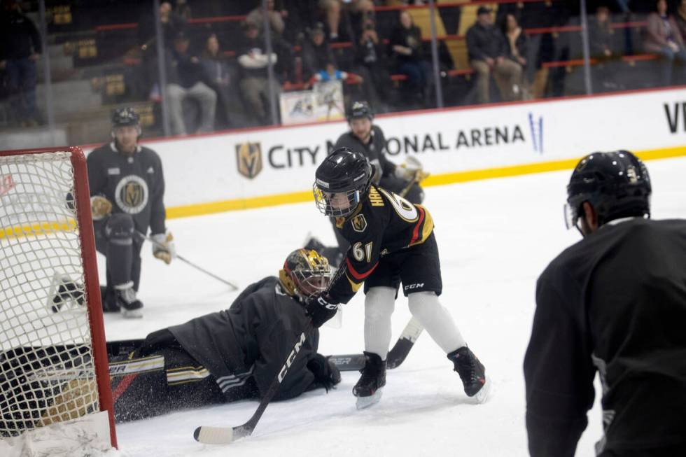 Annabelle Hanson, 8, scores a goal on Golden Knights goaltender Logan Thompson during practice ...