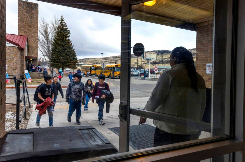 Tribal employee Chrissy Pete welcomes students into the gym at the Owyhee Combined School durin ...