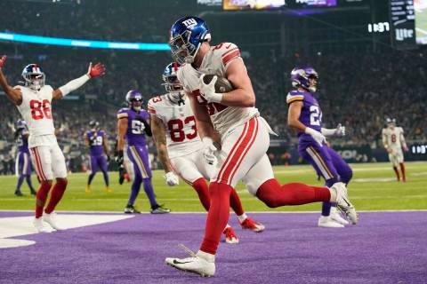 New York Giants' Daniel Bellinger catches a topuchdown pass during the second half of an NFL wi ...