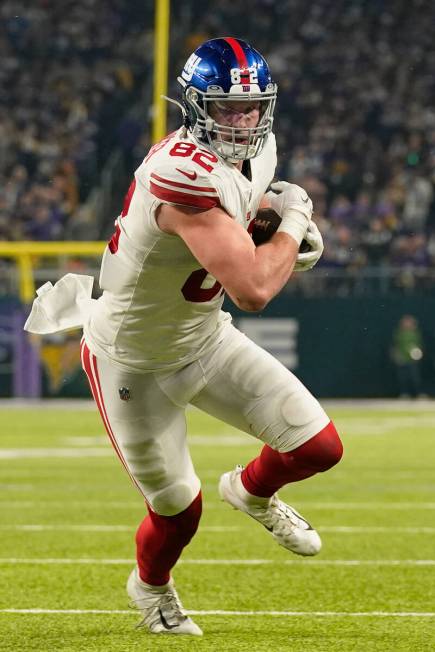 New York Giants' Daniel Bellinger catches a touchdown pass during the second half of an NFL wil ...