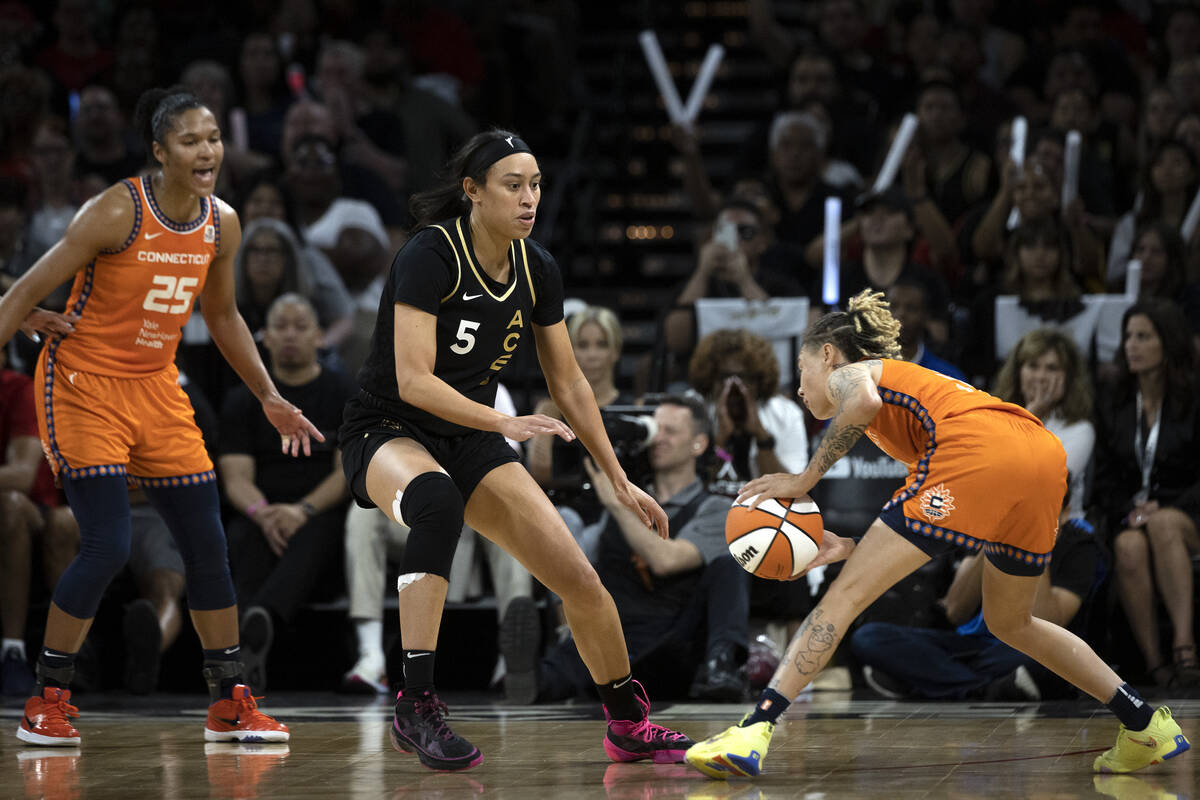 Las Vegas Aces forward Dearica Hamby (5) guards Connecticut Sun guard Natisha Hiedeman (2) whil ...