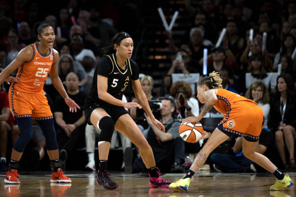 Las Vegas Aces forward Dearica Hamby (5) guards Connecticut Sun guard Natisha Hiedeman (2) whil ...