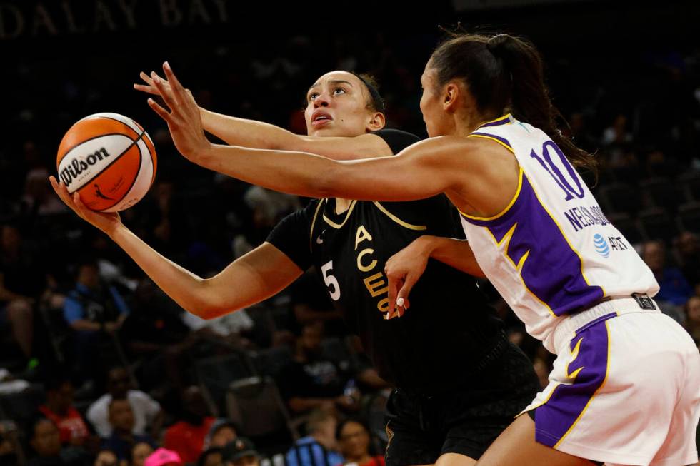 Las Vegas Aces forward Dearica Hamby (5) tries to shoot against Los Angeles Sparks forward Oliv ...