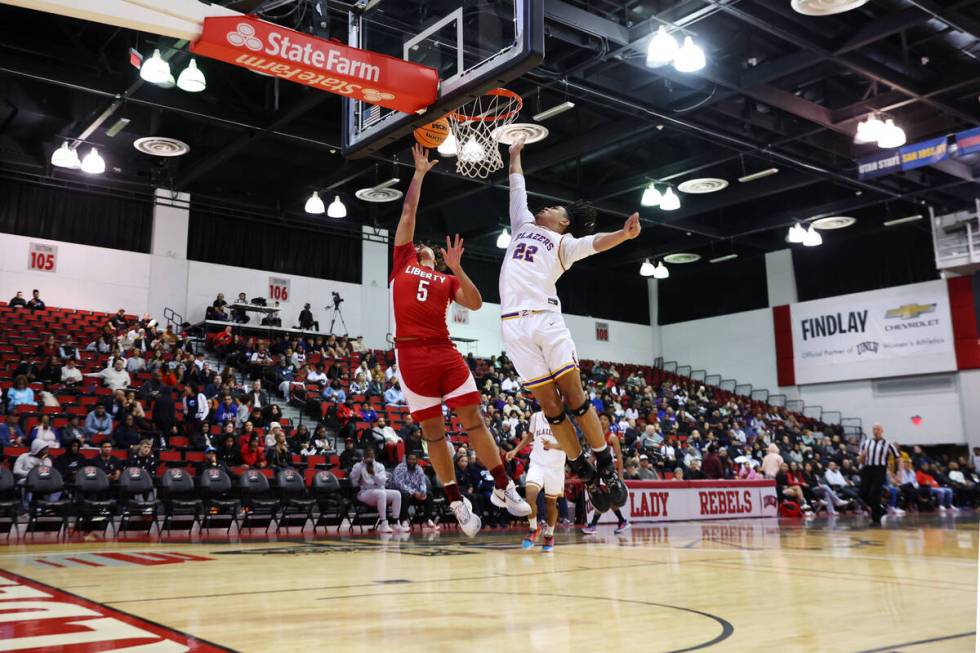 Liberty's Andre Porter (5) takes a shot under pressure from Durango's Michael Bartlett (22) in ...