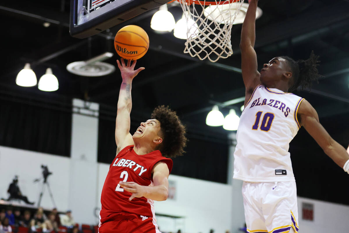 Liberty's Angelo Kambala (2) takes a shot under pressure from Durango's Tylen Riley (10) during ...