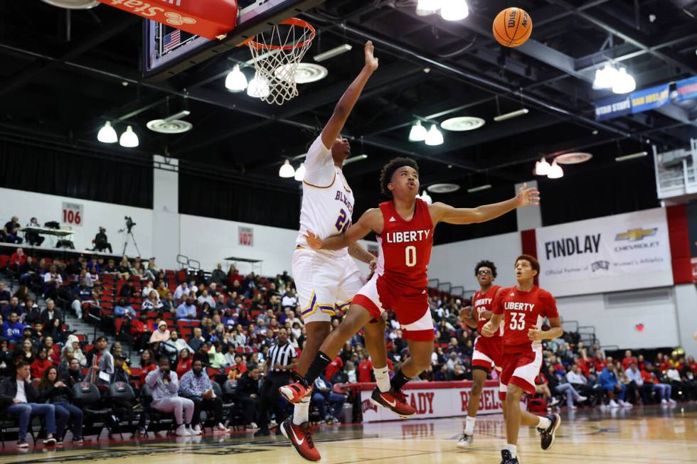 Liberty's Tyus Thomas (0) loses the ball under pressure from Durango's Taj Degourville (24) loo ...