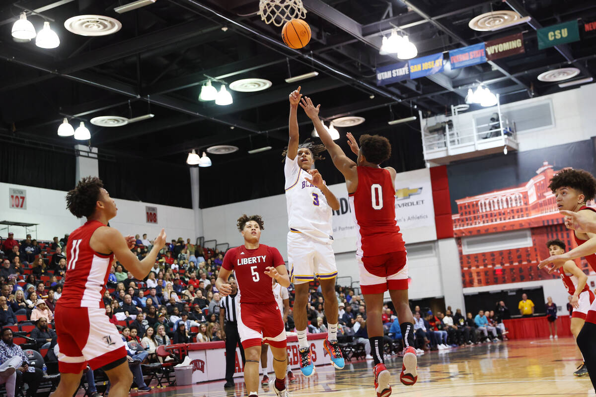 Durango's Jevon Yapi (3) shoots the ball under pressure from Liberty's Tyus Thomas (0) during t ...