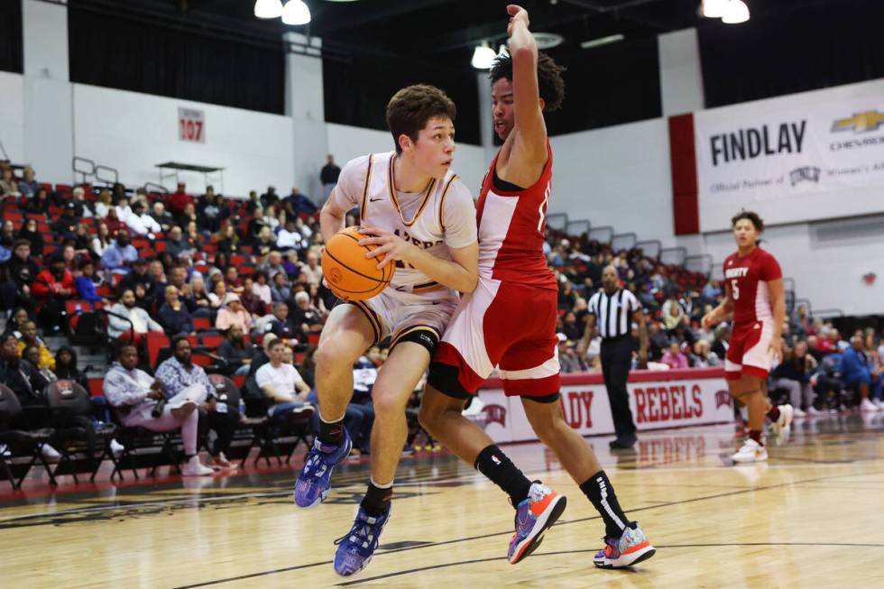 Durango's Colton Knoll (13) looks for an open pass under pressure from Liberty's Dedan Thomas ( ...