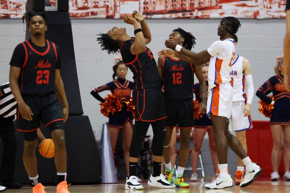 Coronado's Tee Bartlett (13) is fouled by Bishop Gorman's Christopher Nwuli (23) during the fir ...