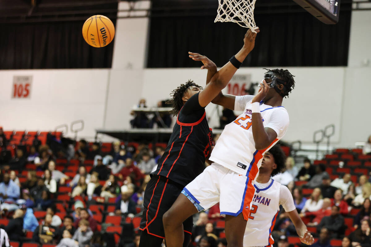 Bishop Gorman's Christopher Nwuli (23) makes a pass under pressure from Coronado's Tee Bartlett ...