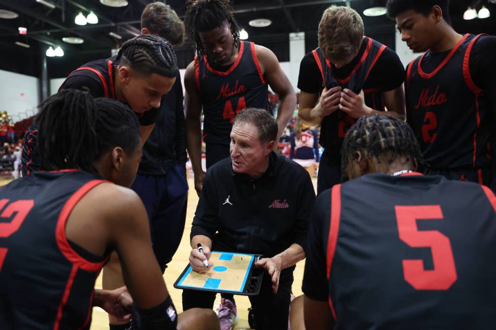 Coronado's head coach Jeff Kaufman speaks to his players during a timeout during the second hal ...