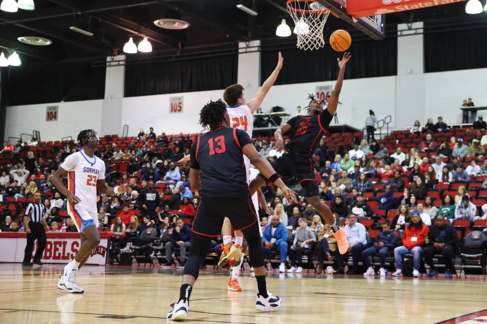 Coronado's Josiah Cunningham (13) shoots the ball for a score while under pressure from Bishop ...