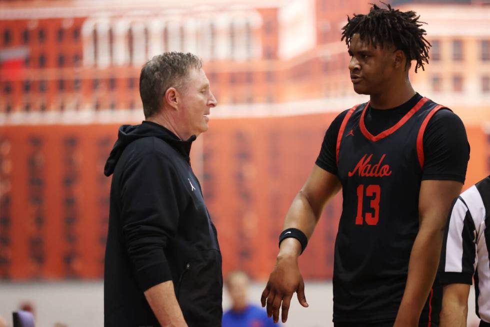 Coronado's head coach Jeff Kaufman, left, talks to his player Tee Bartlett (13) as he walks to ...