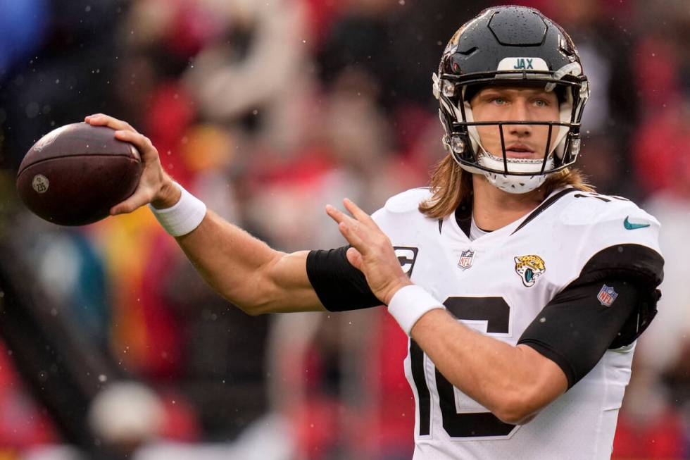 Jacksonville Jaguars quarterback Trevor Lawrence (16) warms up before an NFL divisional round p ...