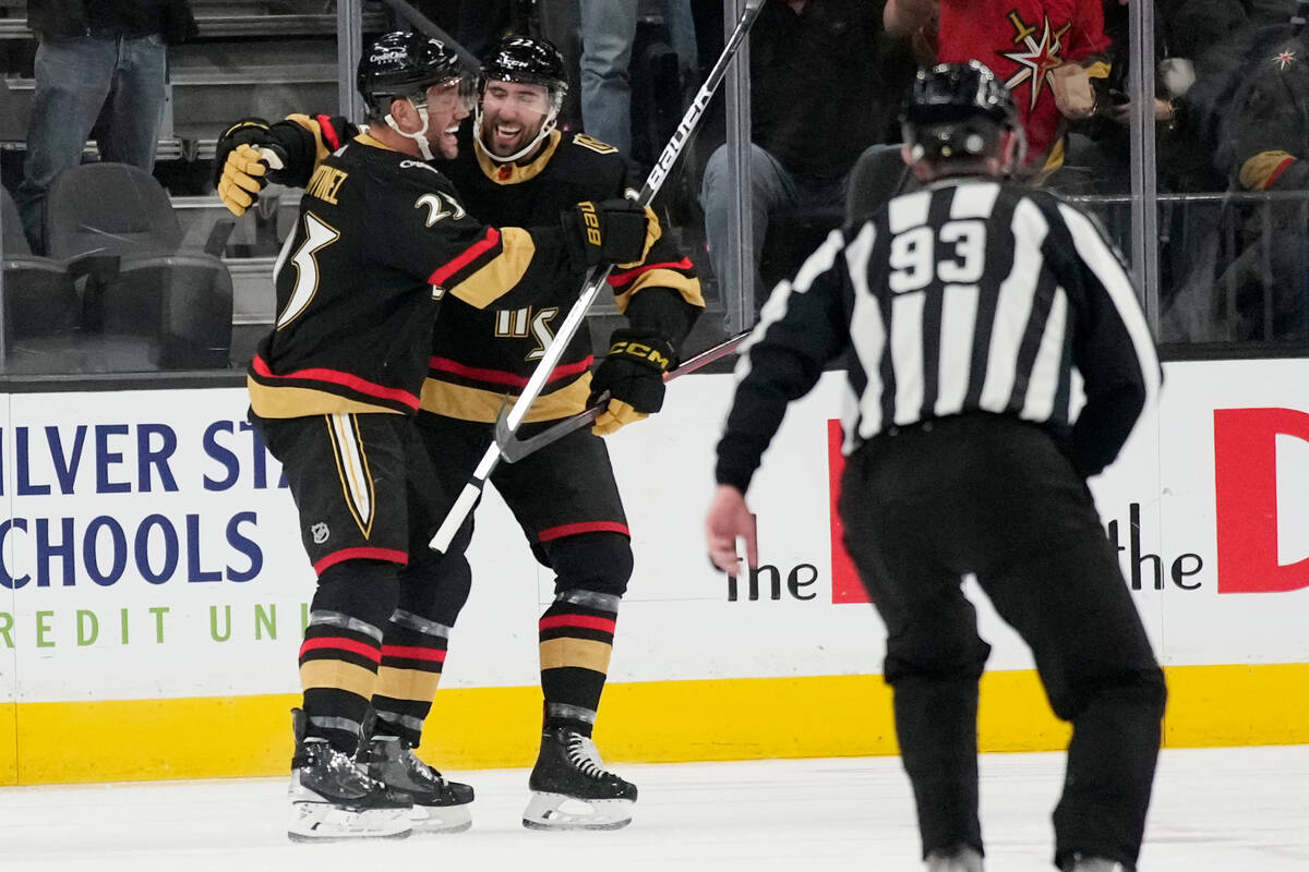 Vegas Golden Knights defenseman Alec Martinez, left, celebrates after scoring against the Washi ...