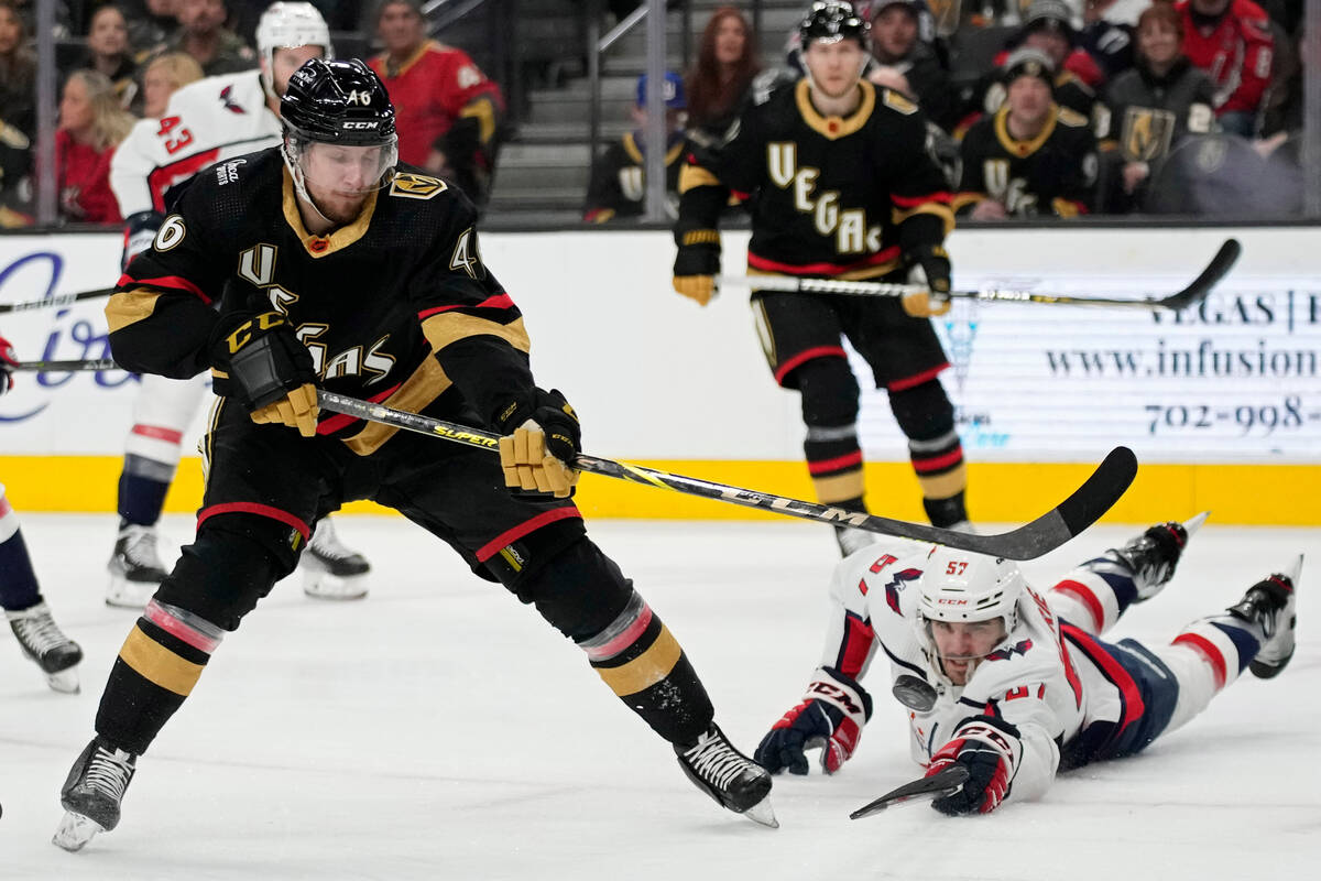 Vegas Golden Knights right wing Jonas Rondbjerg (46) shoots around Washington Capitals defensem ...