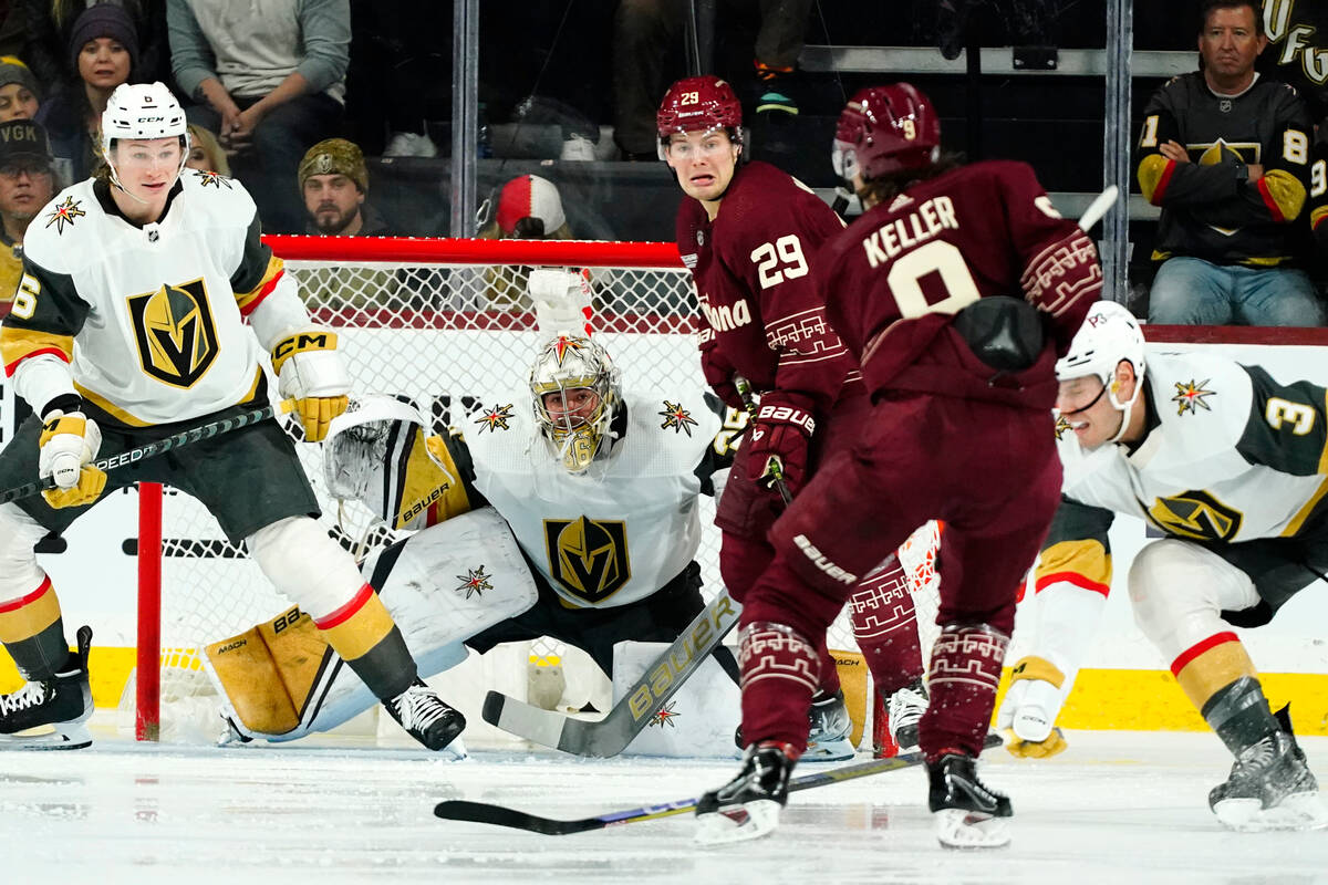 Arizona Coyotes right wing Clayton Keller (9) sends the puck past Vegas Golden Knights defensem ...