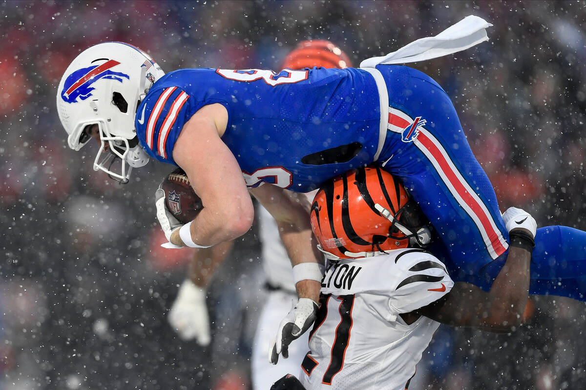 Cincinnati Bengals cornerback Mike Hilton (21) tackles Buffalo Bills tight end Dawson Knox (88) ...