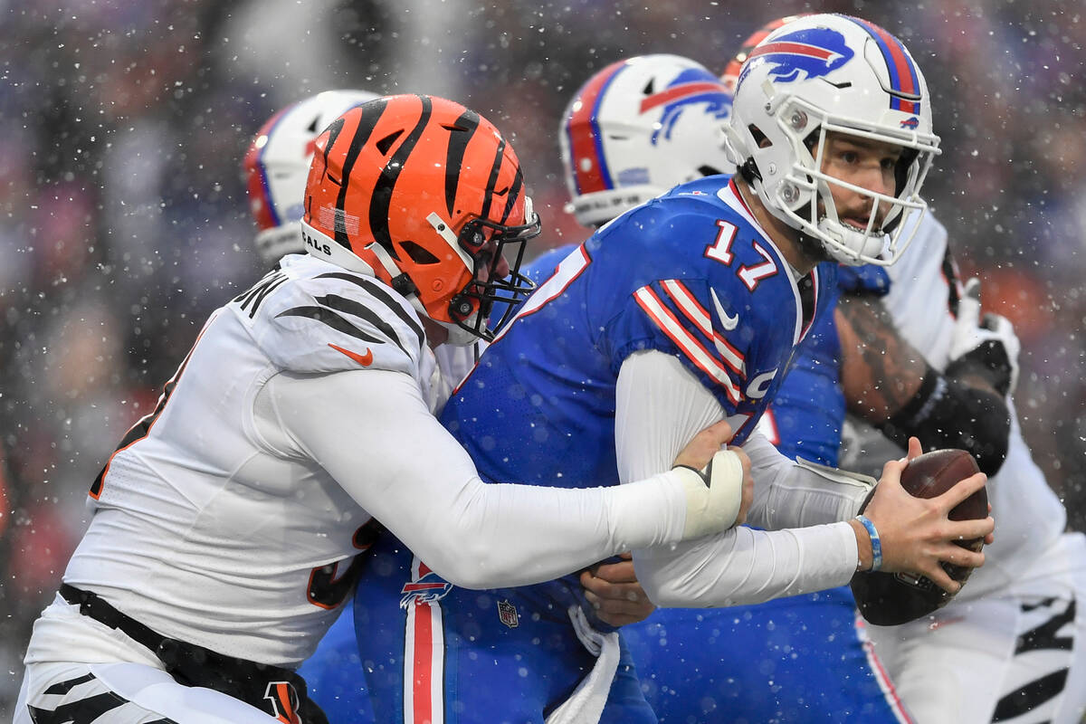 Buffalo Bills quarterback Josh Allen (17) is sacked by Cincinnati Bengals defensive end Trey He ...