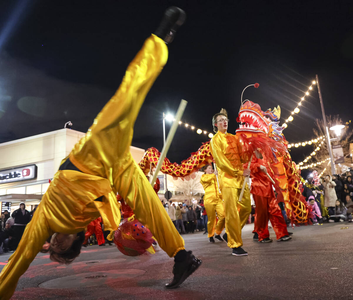 Best Agency performers entertain the crowd with a dragon dance during Downtown Summerlin's Luna ...