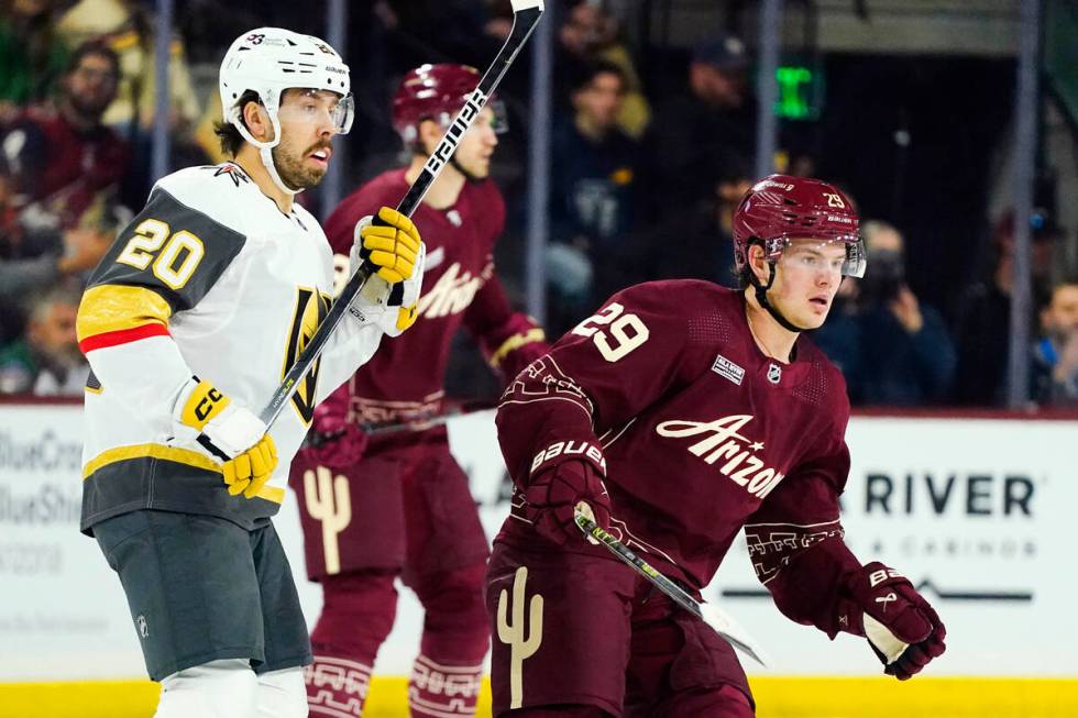 Vegas Golden Knights center Chandler Stephenson (20) and Arizona Coyotes center Barrett Hayton ...