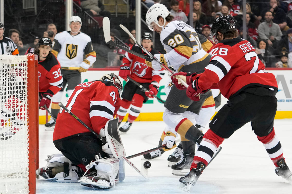 New Jersey Devils goaltender Vitek Vanecek (41) and defenseman Damon Severson (28) tend the net ...