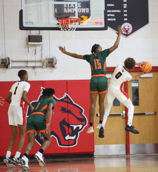 Las Vegas' Jordan Massey (0) tries to shoot around Mojave's Ja'marion Smith (15) during the fir ...