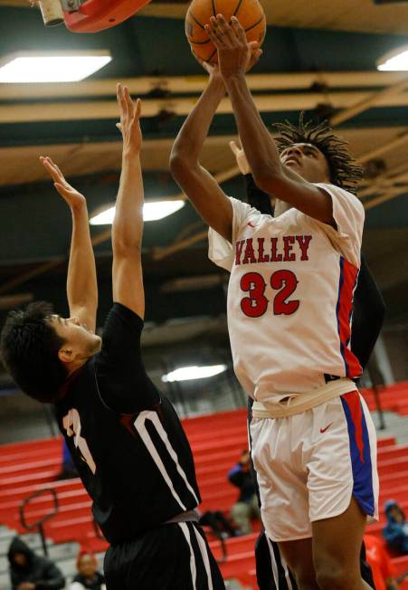 Valley's Xavier Shufford (32) shoots over Desert Oasis' Jayden Jones (3) during the second half ...