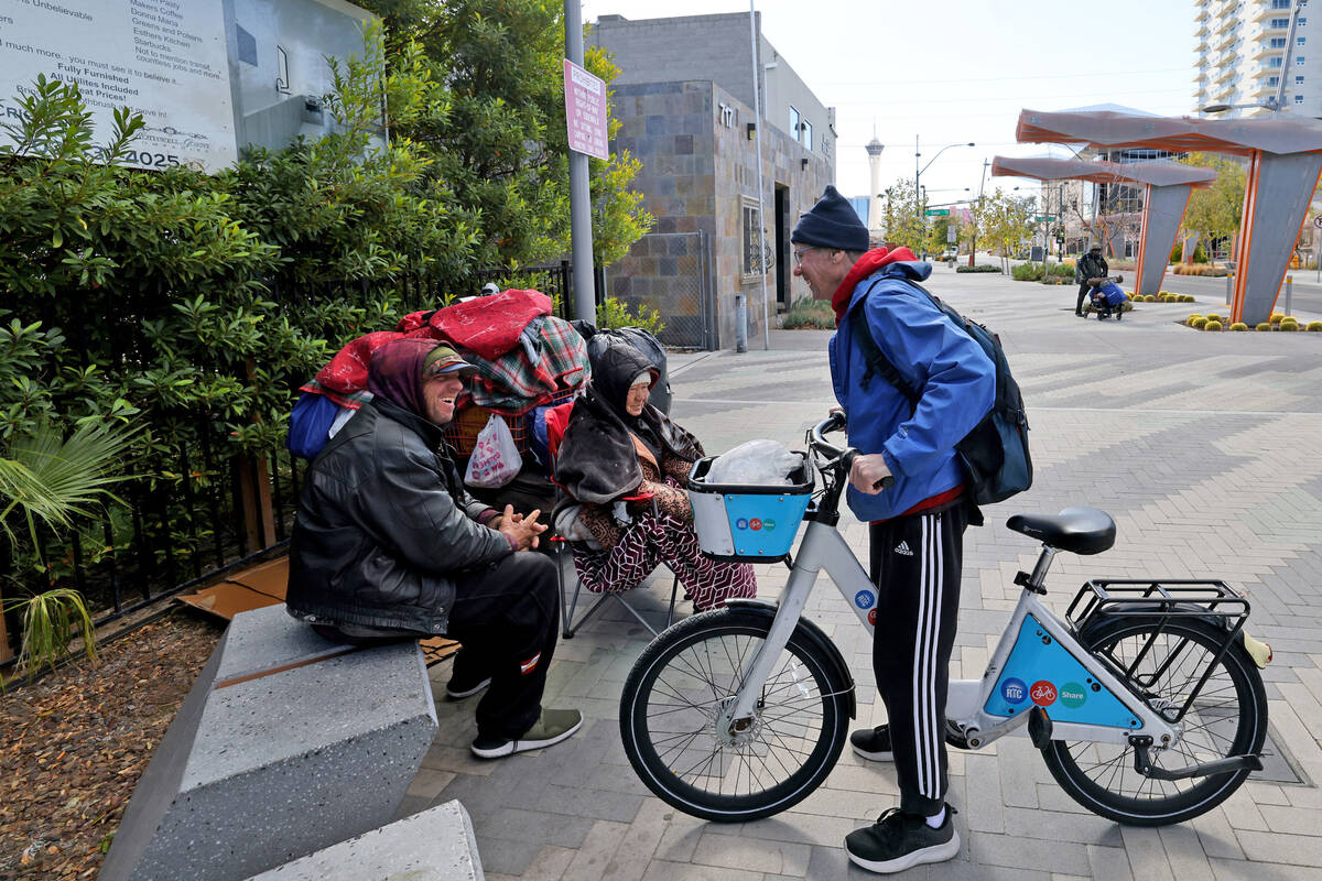 Richard Birmingham, right, talks to Joe Cappara, 56, during his daily bicycle outreach ride in ...